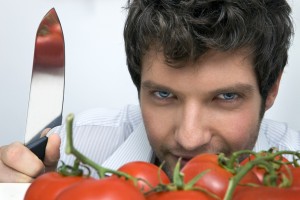 700-02756603 © Siephoto Model Release: Yes Property Release: No Man With Knife and Tomatoes